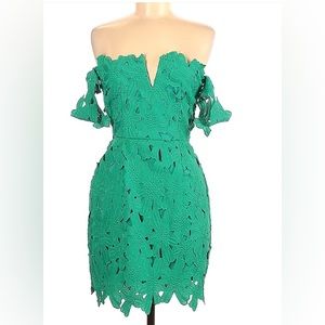 Off the shoulder green cocktail dress with open back and laser cut floral detail